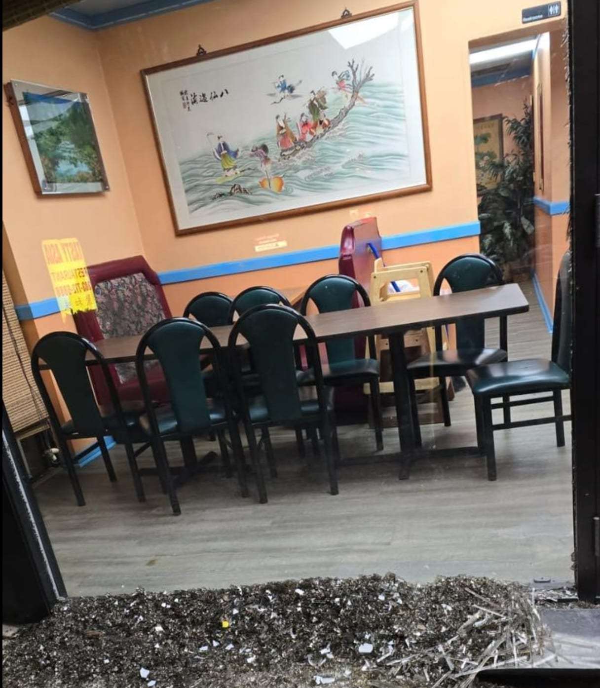 Restaurant dining area with debris on the floor